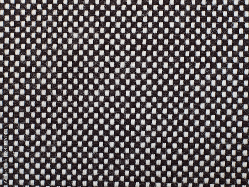 Black and white checkred woven material, texture or background.