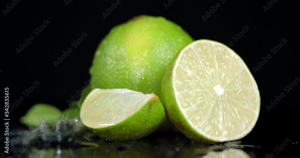 Half and whole lime falling water drops. Half and whole lime falling water drops.