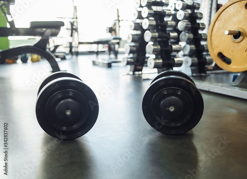 Two heavy dumbbells close-up in the gym