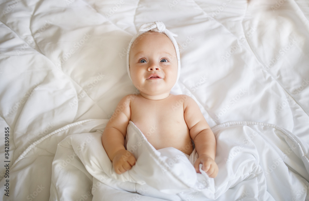 Cute baby in a blanket,smiles and laughs Cute baby in a blanket,smiles and laughs