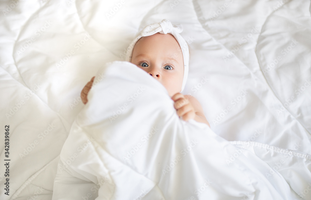 Cute baby in a blanket,smiles and laughs Cute baby in a blanket,smiles and laughs