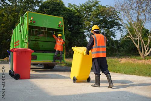 Bilde på lerret Garbage collector Worker of urban municipal recycling garbage collector truck lo