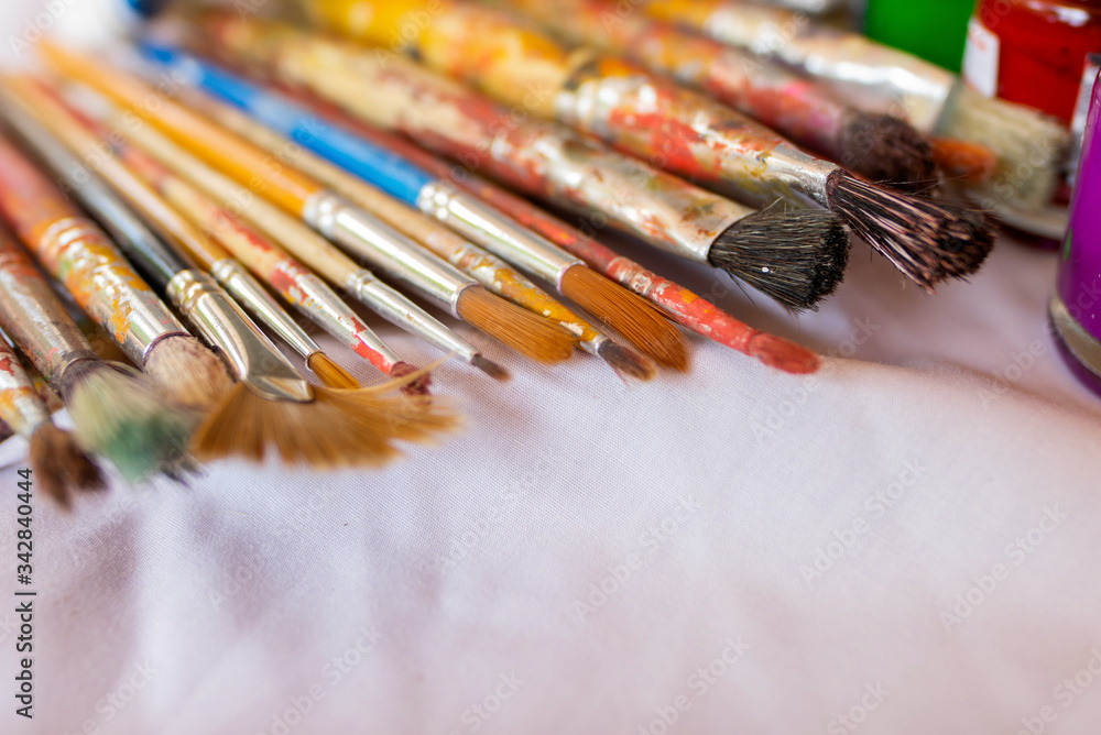 Fototapeta premium Paintbrush placed on a white cloth, Art Education, Learning to the 21st century, Stem studies.Selectively focus on specific points and blur in the image.