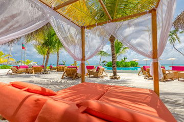 White beach canopies. Luxury beach tents at a resort. Wonderful view of beach scenery, luxury vacation and travel background concept
