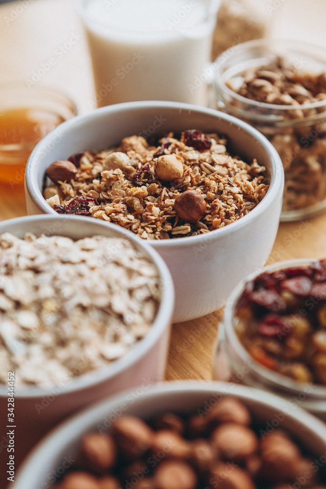 a delicious and crunchy oatmeal granola with honey, nuts, dried fruits and grains. Dynamic healthy food photography a delicious and crunchy oatmeal granola with honey, nuts, dried fruits and grains. Dynamic healthy food photography