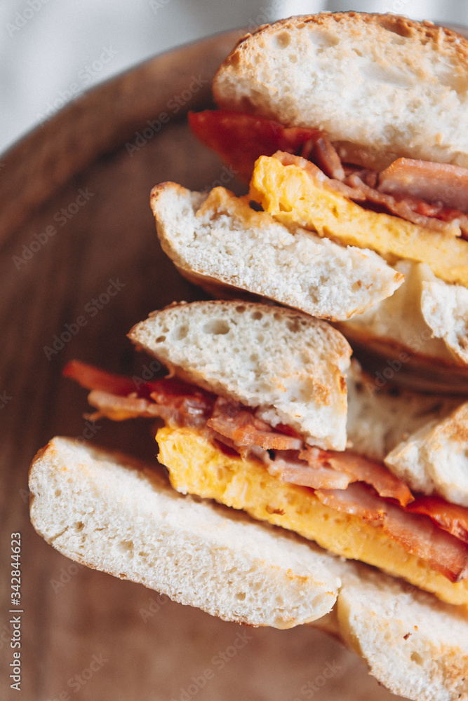 cut in half a bagel which is full of delicious juicy stuffing. Appetizing breakfast close up cut in half a bagel which is full of delicious juicy stuffing. Appetizing breakfast close up