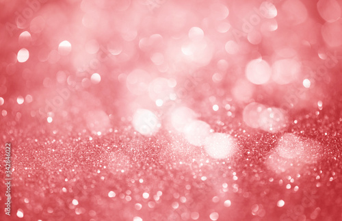 Pink glittering Christmas lights. Blurred abstract background