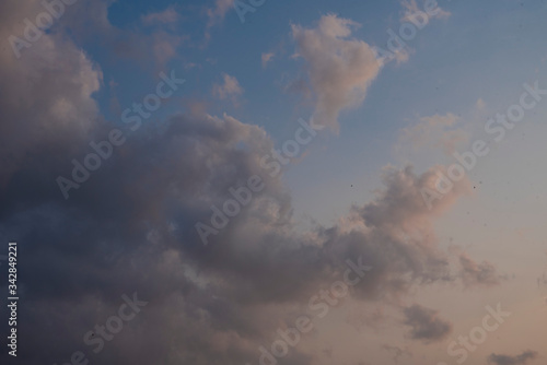 Beautiful clouds roaming in the red and bluish sky during sunset in the afternoon. Indian landscape and sky.