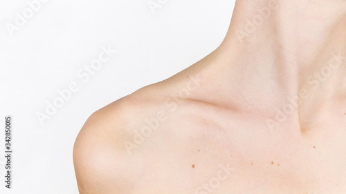 Graceful forms of the girl. Neck, shoulder and collarbone, of a young beautiful woman near. The concept of beauty, skin and body care.