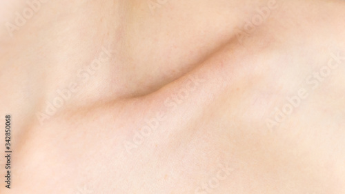 Collarbone. Detailed texture of human skin. Close up shot of a young caucasian female body. Skin care, body care, healthcare, hygiene and medicine. Nice and well maintained. Dermatology.