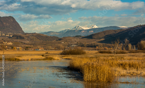View on the popular Lake Caldaro on the South Tyrolean Wine Route near Bolzano, Italy, Europe. Winter landscape Caldaro lake. warmest swimming lake in the Alps.