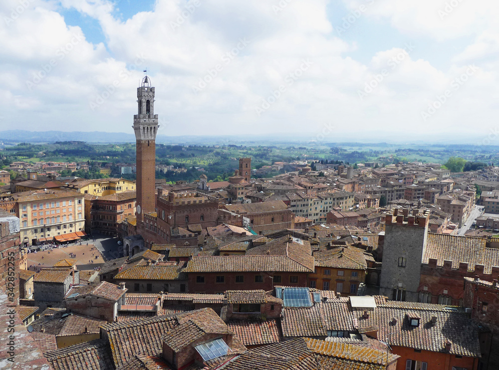 Cityscape with the tower of the Comunale Palace. City of Siena. Tuscany. Italy.