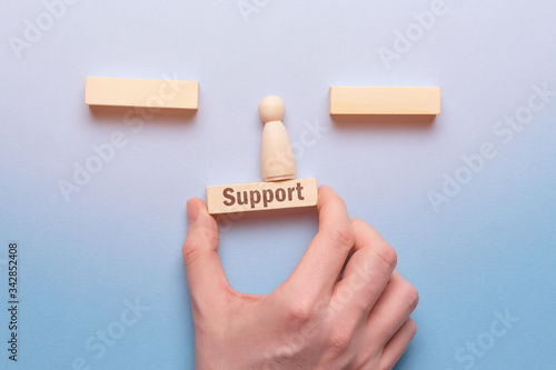 Support business concept with hand text and wooden block.