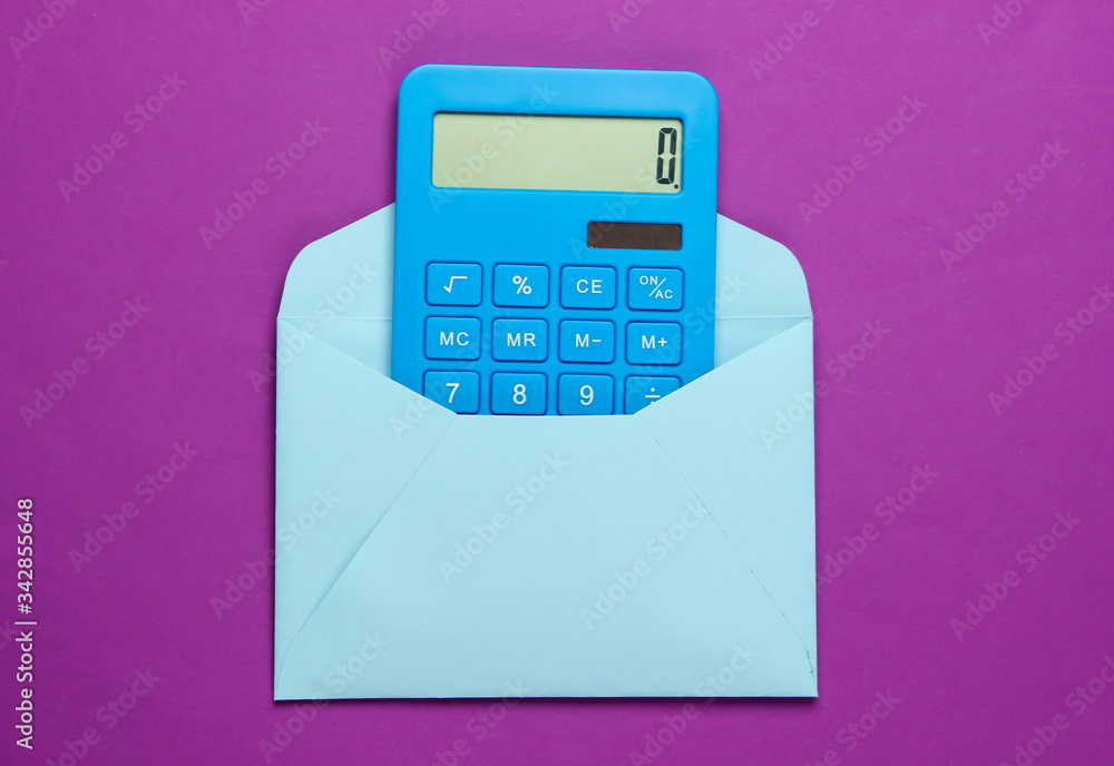 Calculator with an envelope on a purple background. Top view Calculator with an envelope on a purple background. Top view