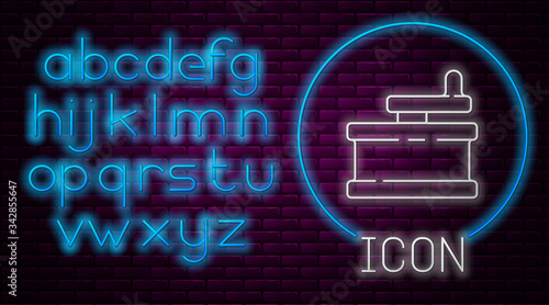 Glowing neon line Manual grinder icon isolated on brick wall background. Neon light alphabet. Vector Illustration
