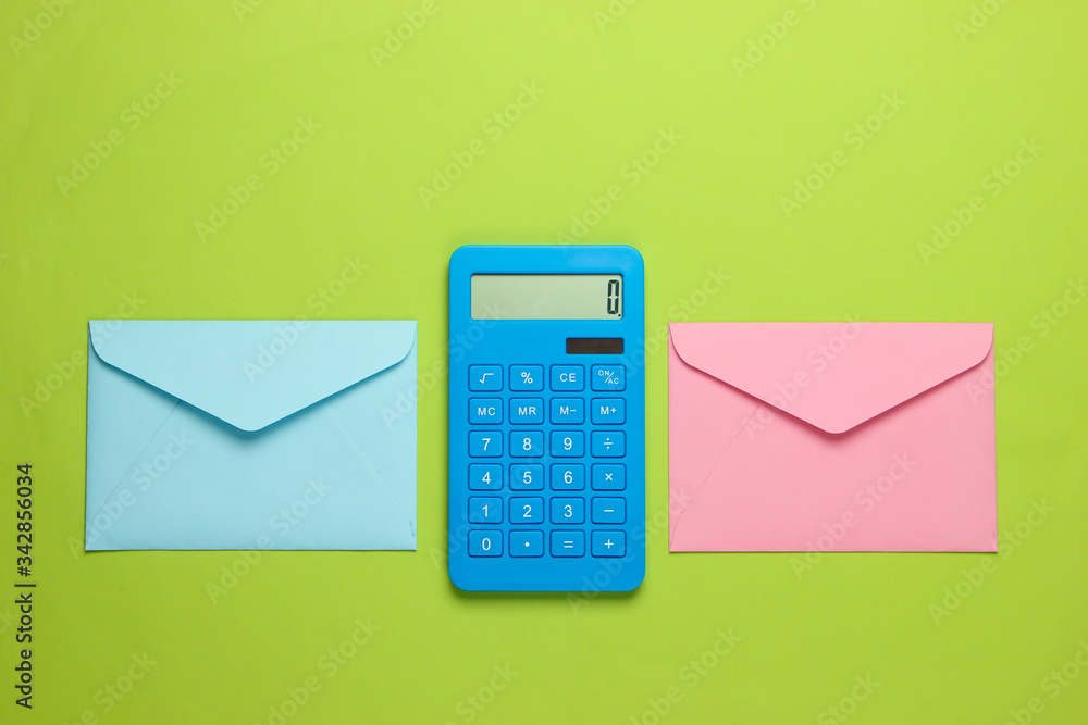 Calculator with envelopes on green background. Top view Calculator with envelopes on green background. Top view