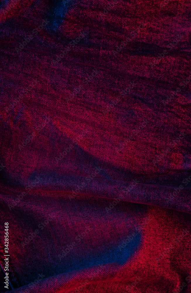 Jeans in a neon blue-red gradient light. Jeans in a neon blue-red gradient light.