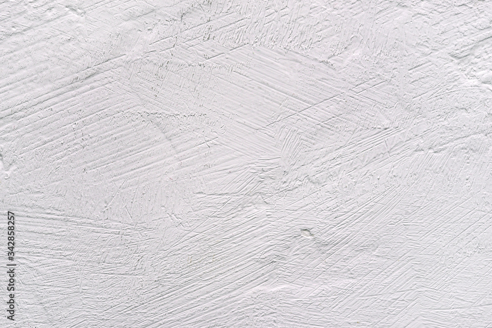 White background with a textured surface. Plastered wall or table.