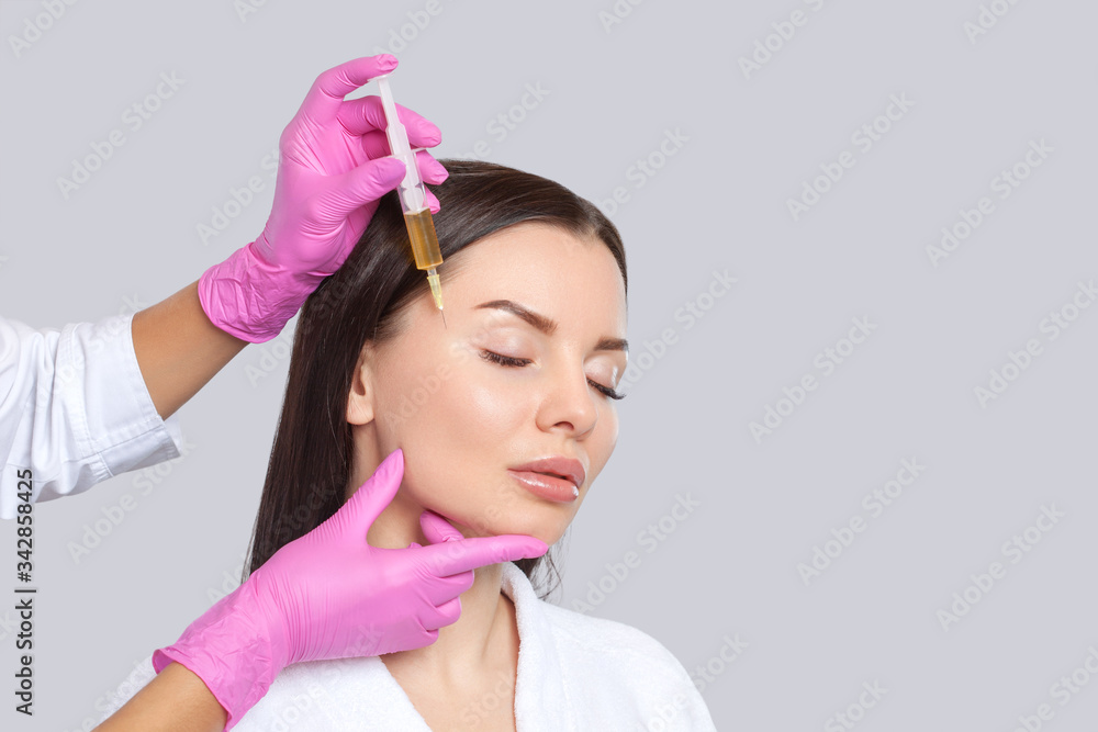 Cosmetologist does prp therapy anti wrinkle and aging skin on the face of a beautiful woman in a beauty salon. Cosmetology concept. Cosmetologist does prp therapy anti wrinkle and aging skin on the face of a beautiful woman in a beauty salon. Cosmetology concept.