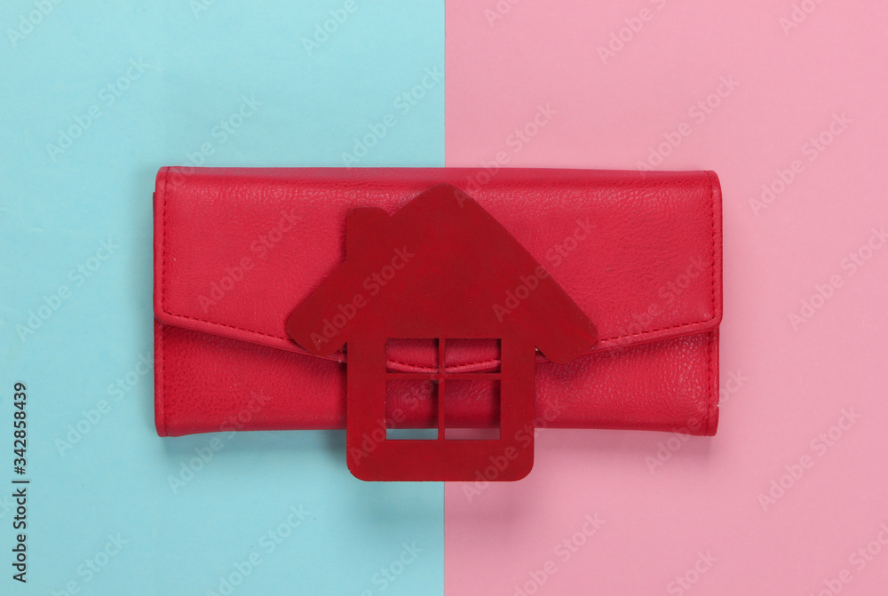 Obraz premium Family budget management. Figurine of a house with wallet on pink blue pastel background. Top view