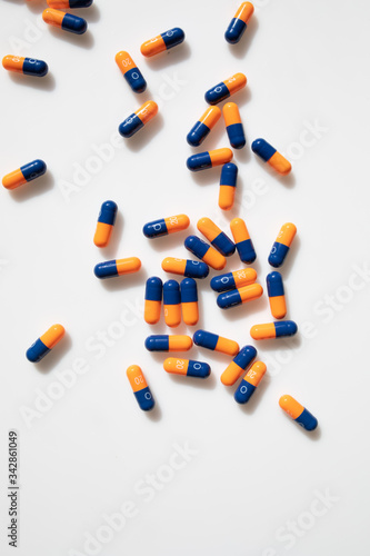 
orange and blue pills on a white backgroun