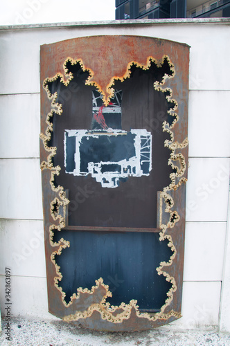 Big old rusty metal box for advertisements with interesting figured carving