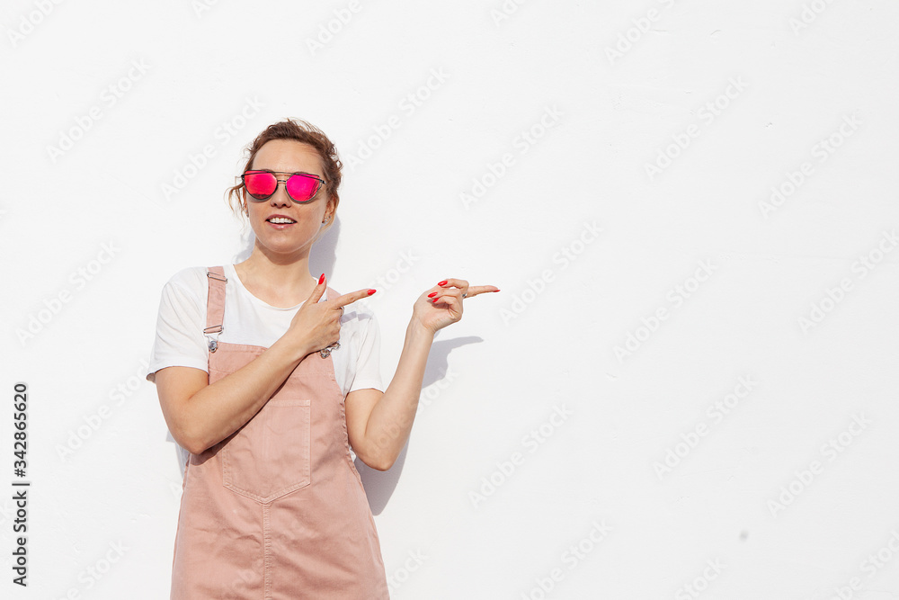 Excited Young Woman In Glasses Pointing Her Index Finger Sideways