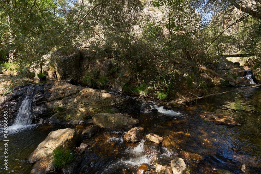 Obraz premium Beautiful waterfall in Penedo Furado Passadico walkway in Vila de Rei, Portugal