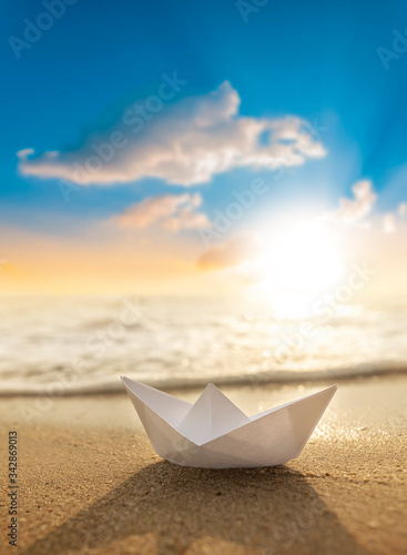 A paper boat on a beautiful beach 