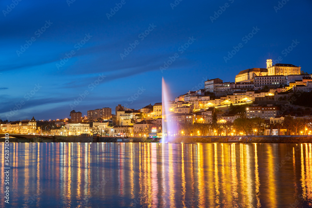 Coimbra city view at night with Mondego river and beautiful historic buildings, in Portugal
