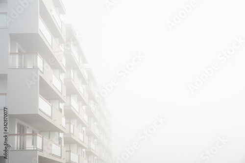 Modern apartment buildings in a foggy morning