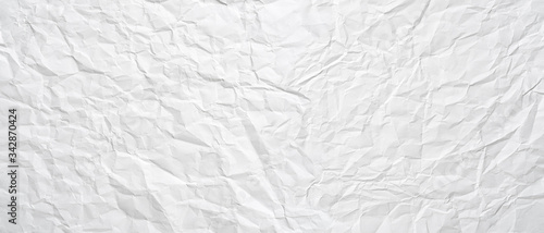 Texture of a white crumpled sheet of paper as a background