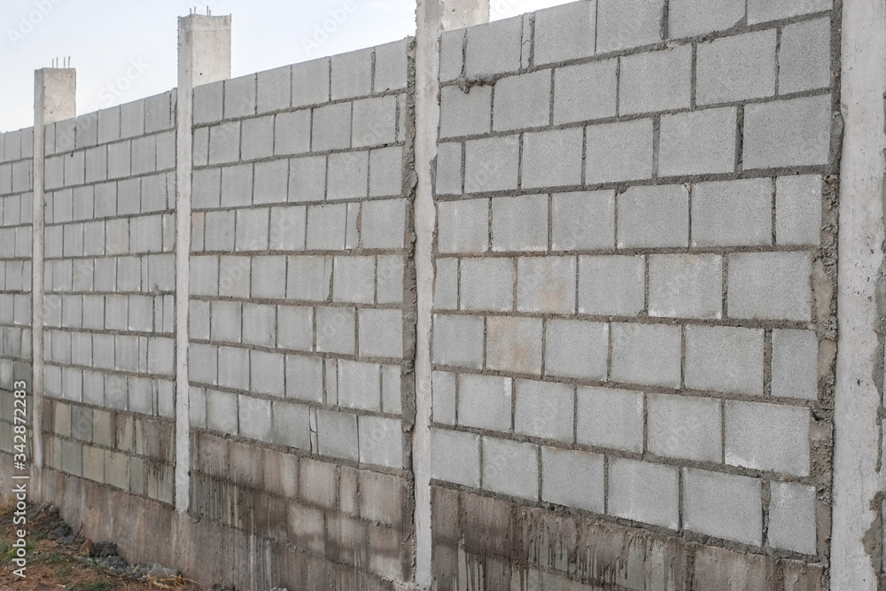 Fototapeta premium White cement brick wall pattern close-up.
