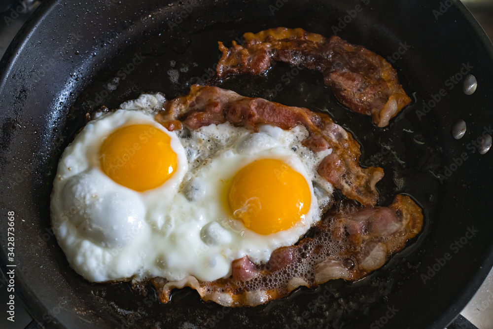 Breakfast with fried eggs and bacon closeup. Food phorography Breakfast with fried eggs and bacon closeup. Food phorography