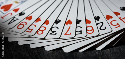 Playing cards fanned out on a black background. The concept of the game.