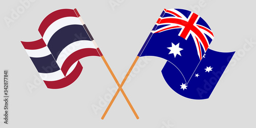Crossed and waving flags of Australia and Thailand