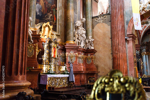 Nun near the altar in Interior of a medieval catholic cathedral.