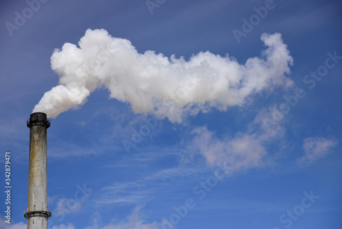 Smoke stack emissions, blue sky and clouds, sugar mill in Nebraska, USA