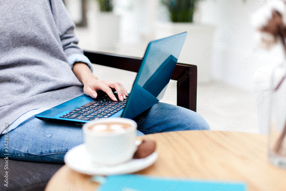 Remote working from home office. Freelancer workplace with laptop, coffee in cafe. Concept of distance learning, teleworking, female business, shopping online. Close up of woman hands. Remote working from home office. Freelancer workplace with laptop, coffee in cafe. Concept of distance learning, teleworking, female business, shopping online. Close up of woman hands.