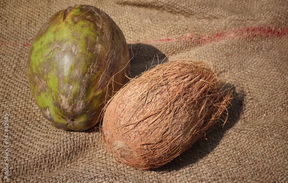 Fototapeta premium Coconuts on Burlap Background, Perfect for Wallpaper