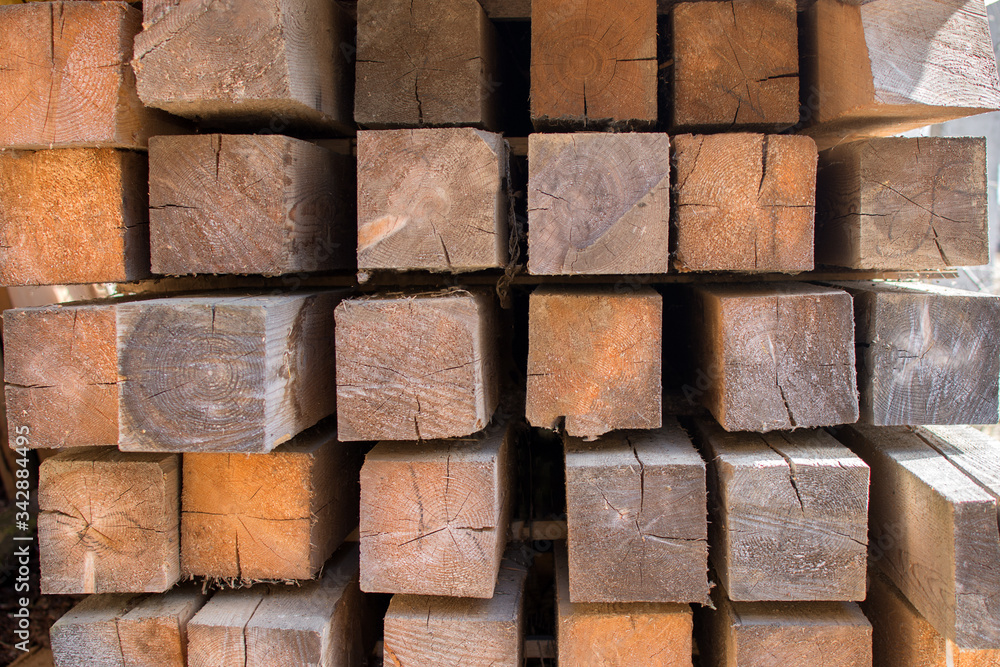 the square bar intended for construction is carefully laid in rows. Close-up photo, cropped the square bar intended for construction is carefully laid in rows. Close-up photo, cropped