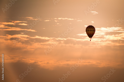 Hot air balloon floating by at sunset in Michigan