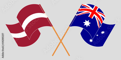 Crossed and waving flags of Australia and Latvia