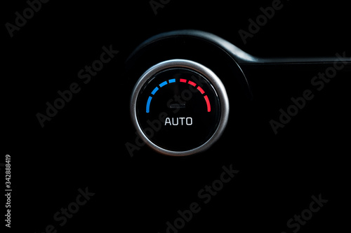 Car air button on a black background, with indicator.
