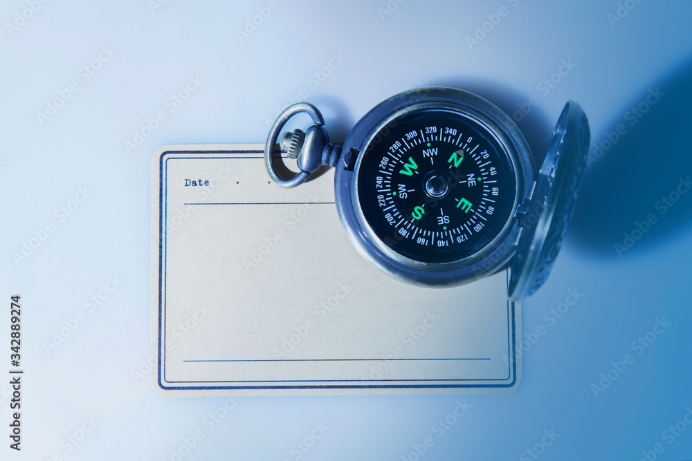Top view of a compass and paper with copy space for text. Top view of a compass and paper with copy space for text.
