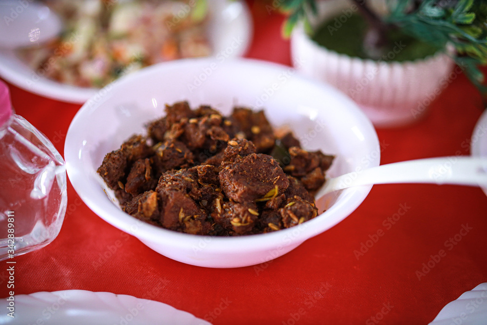 Kerala style beef dry fry. delicious spicy Beef fry in banquet table with chafing dish heaters. It goes well with ghee rice, kappa,appam, parotta, puttu, Kerala style cuisine ,beef roast.India Kerala style beef dry fry. delicious spicy Beef fry in banquet table with chafing dish heaters. It goes well with ghee rice, kappa,appam, parotta, puttu, Kerala style cuisine ,beef roast.India