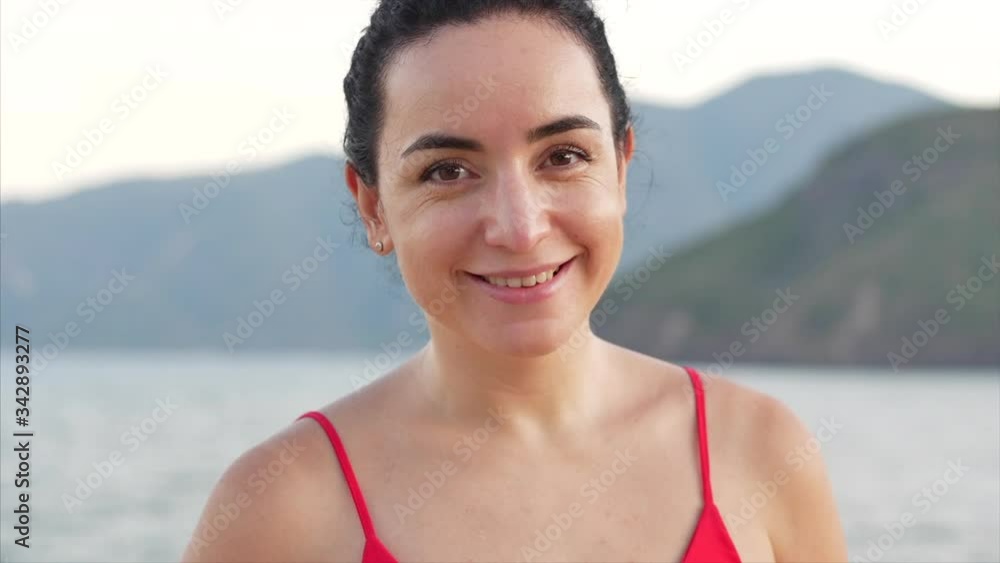 Portrait of a mixed race student young woman the background of the nature of beautiful mountains and blue sea. On a Tropical Beach Close-Up Portrait of European Beautiful Cute Girl. Portrait of a mixed race student young woman the background of the nature of beautiful mountains and blue sea. On a Tropical Beach Close-Up Portrait of European Beautiful Cute Girl.