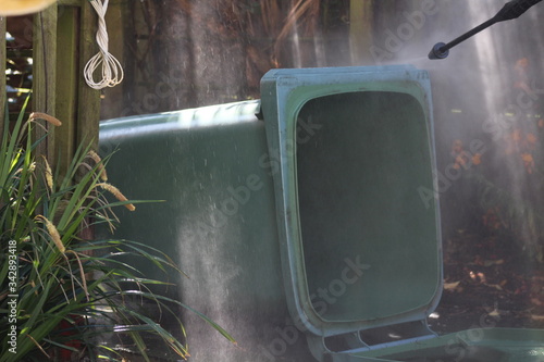 jet washing the wheely bin 