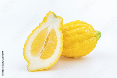 Typical sicilian lemon Piretto and its cutted slice isolated on white background