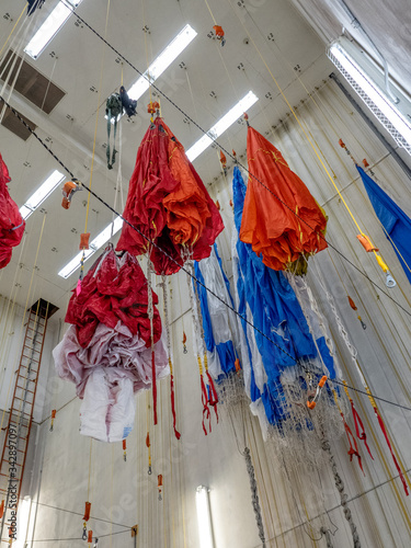 Parachutes hanging from ceiling after being checked and waiting for folding and packing prior to taking next fire jumper out to fight a wildfire. photo